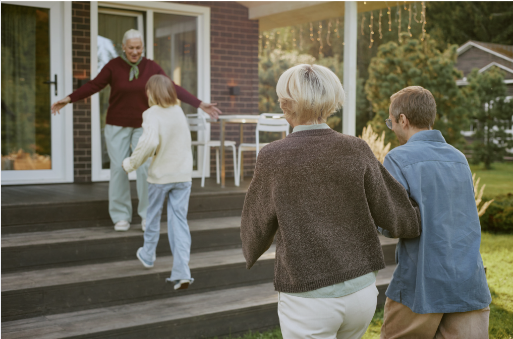 Grandmother greeting family at home